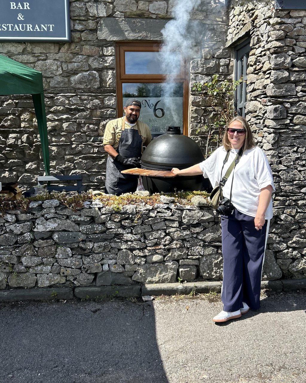 The Railway Inn's stone frontage on London Road, Lindal-in-Furness, with the kamado smoking out front