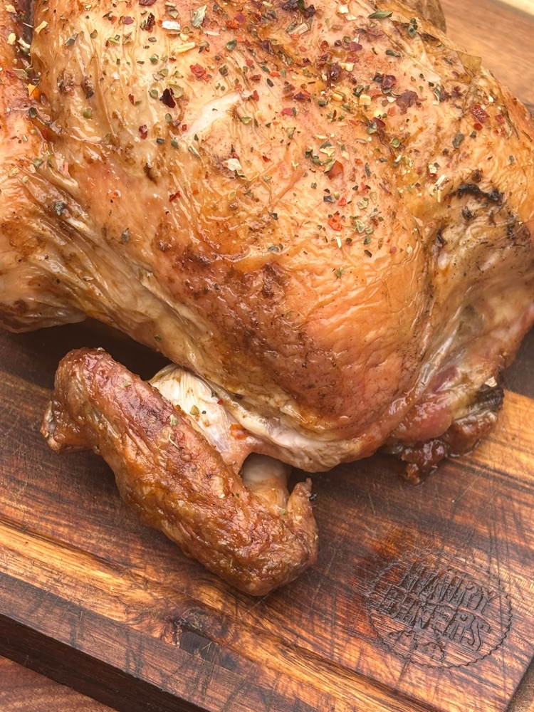 A whole roast chicken rested on a board at Light & Salt Provisions.